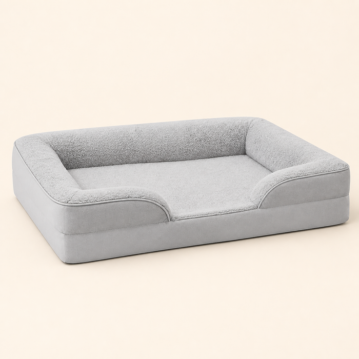 Gray raised-bolster dog bed on a warm ivory studio background