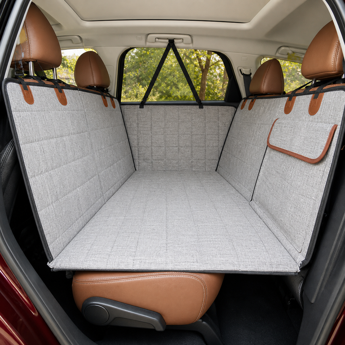 Gray rear-seat dog travel bed and cover installed in an SUV