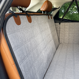 Close view of the gray travel bed quilting and headrest attachments