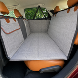 Gray rear-seat dog travel bed viewed from the opposite door