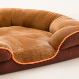 Close view of the brown bed fabric, orange piping, and low front entry