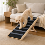 Small dog using the GlideStep pet ramp beside a sofa