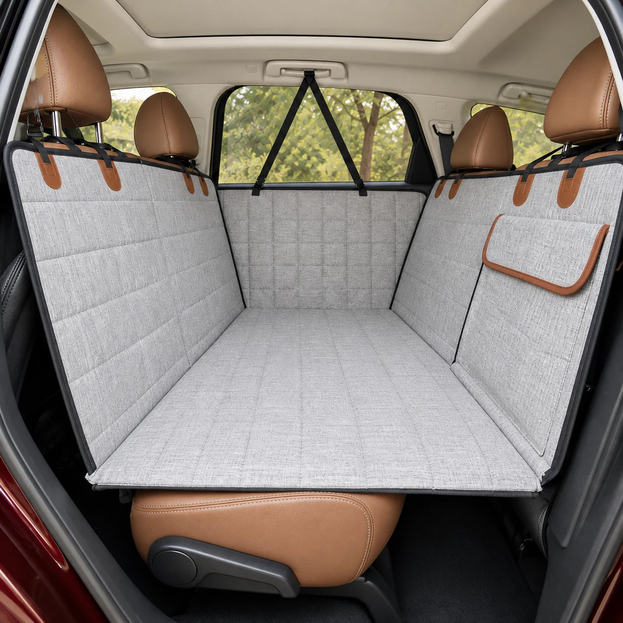 Gray rear-seat dog travel bed and cover installed in an SUV